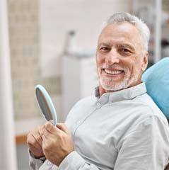 Man smiling after receiving dental implants in Cleveland TX