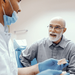 Denture dentist in Cleveland talking patient