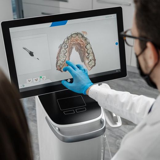 Dentist using CAD to design digital dentures