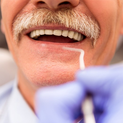 New denture patient receiving an exam