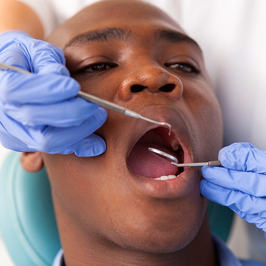 Patient receiving oral cancer screening