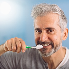 Man practicing dental implant care in Cleveland