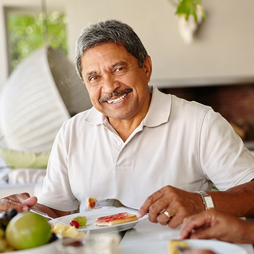 Man sharing full smile after dental implant tooth replacement