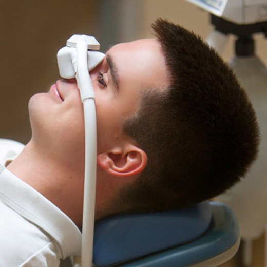 Relaxed man wearing nasal mask for nitrous oxide sedation in Cleveland, TX