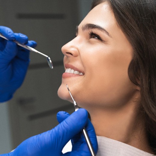 patient smiling while looking at dentist 