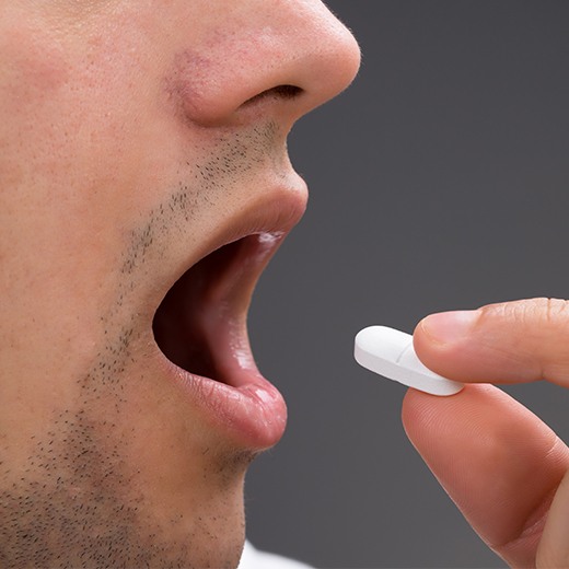 Patient taking oral conscious dental sedation pill