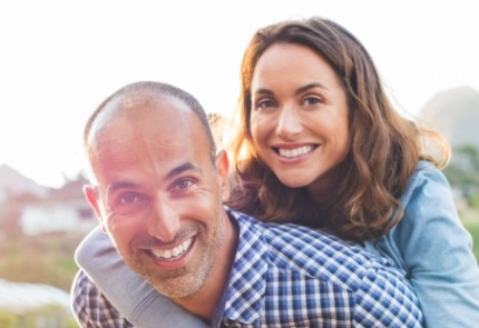 Man and woman smiling after dental exam and consultation visit