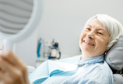 Woman smiling after denture repair or reline