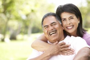 Smiling healthy couple with dental implants in Cleveland