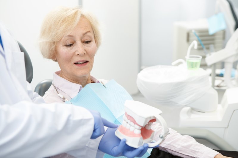 Older woman inquiring about dental implants