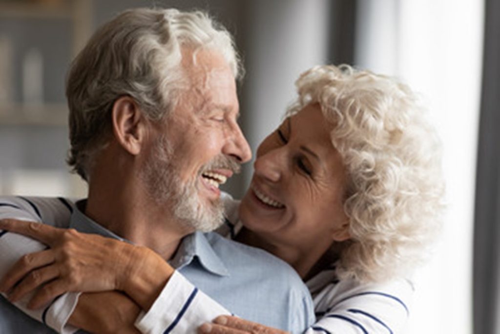 Older couple with implant dentures.