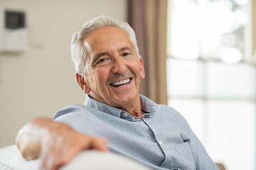 person smiling after having lower denture fixed