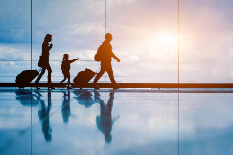 A family at the airport after the father's dental implant surgery