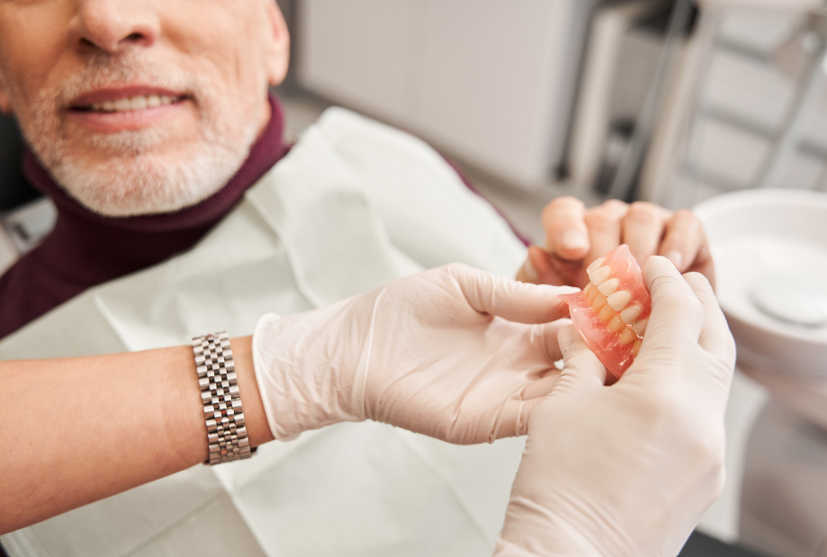 Dentist showing patient dentures